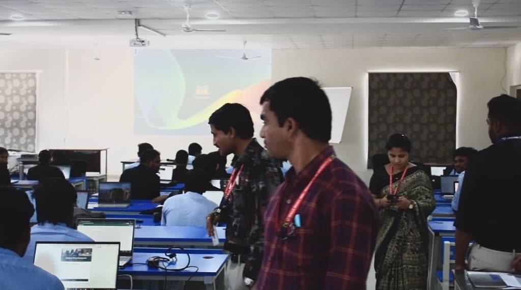 Learners at the desks with the class screen on